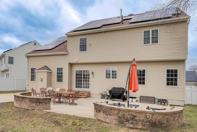 back of house featuring solar panels and a patio