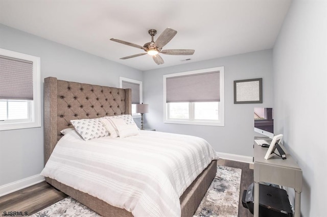 bedroom with ceiling fan and dark hardwood / wood-style flooring