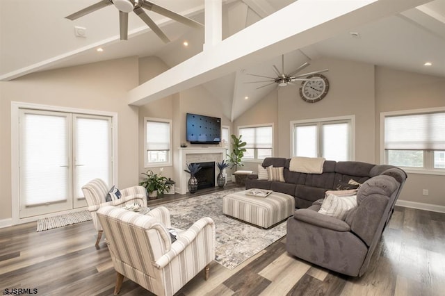 living room featuring a healthy amount of sunlight, beam ceiling, dark hardwood / wood-style floors, and ceiling fan