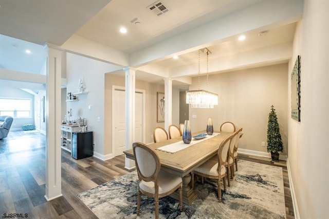 dining space with ornate columns and hardwood / wood-style floors