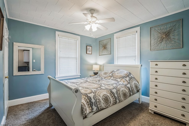 bedroom featuring dark colored carpet, ceiling fan, and ornamental molding