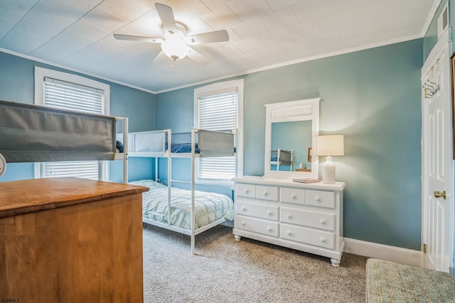 bedroom with ceiling fan, light colored carpet, and ornamental molding