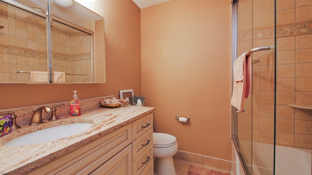 full bathroom with tile patterned flooring, vanity, toilet, and bath / shower combo with glass door