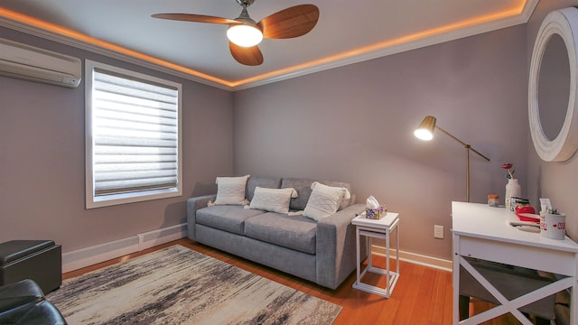 living room featuring wood-type flooring, a wall mounted AC, ornamental molding, and ceiling fan