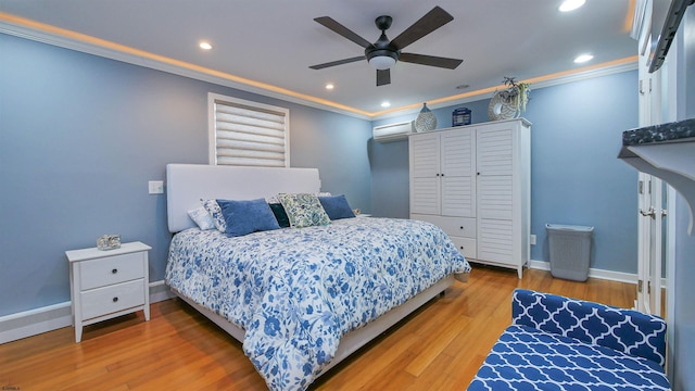 bedroom with a wall mounted air conditioner, hardwood / wood-style floors, ceiling fan, ornamental molding, and a closet