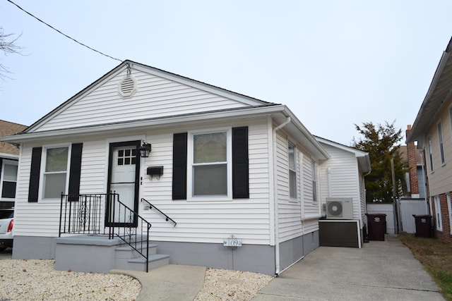 bungalow featuring ac unit