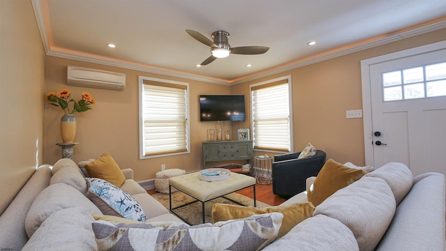 living room featuring hardwood / wood-style floors, an AC wall unit, ornamental molding, and a healthy amount of sunlight