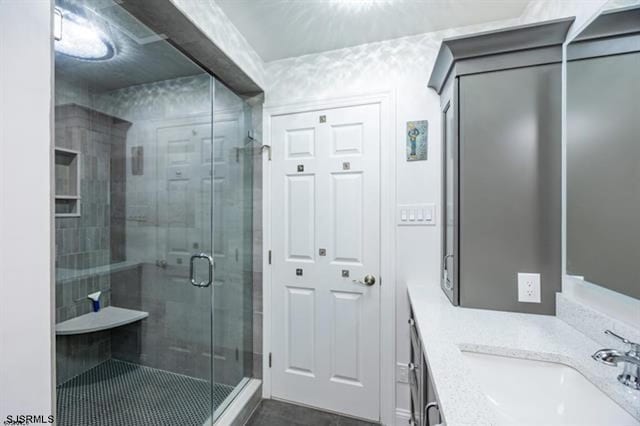 bathroom featuring an enclosed shower and vanity