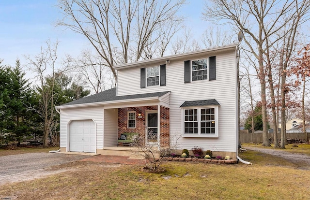 front facade featuring covered porch, a front lawn, and a garage