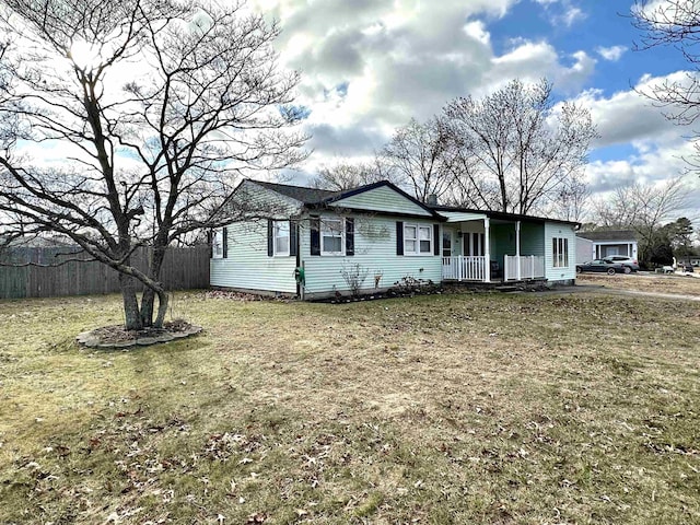 single story home featuring covered porch and a front lawn