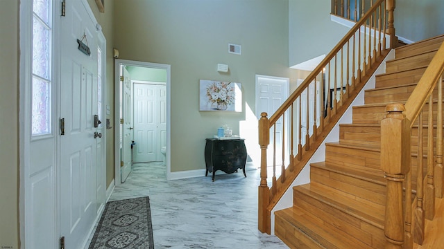 entrance foyer featuring a towering ceiling