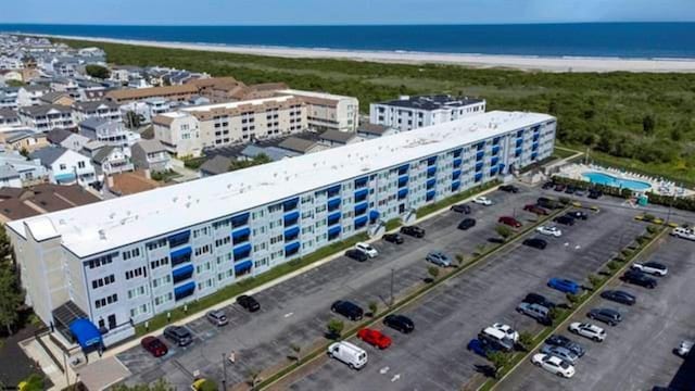 birds eye view of property with a view of the beach and a water view