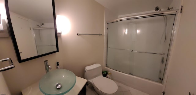 full bathroom featuring vanity, toilet, and shower / bath combination with glass door