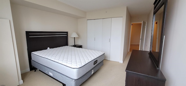 bedroom with a closet and light colored carpet