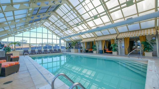 view of swimming pool featuring a lanai and a patio