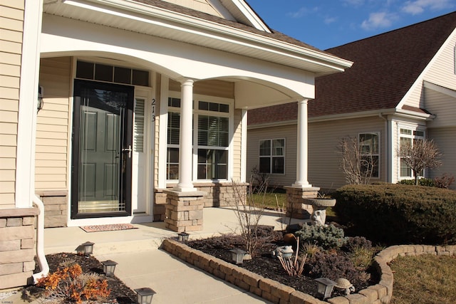 view of exterior entry featuring a porch