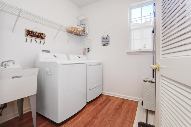 washroom featuring washer and clothes dryer and hardwood / wood-style flooring