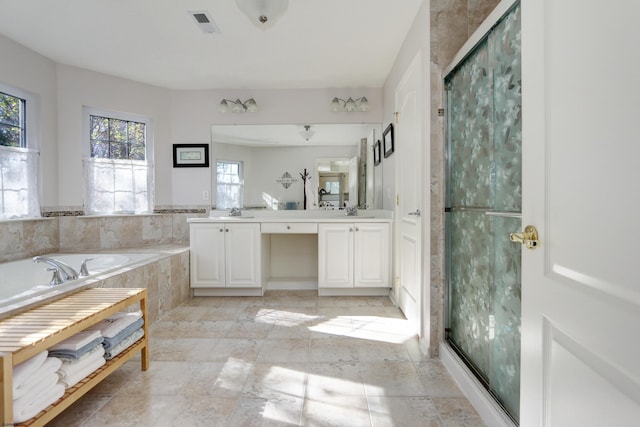 bathroom featuring vanity and shower with separate bathtub