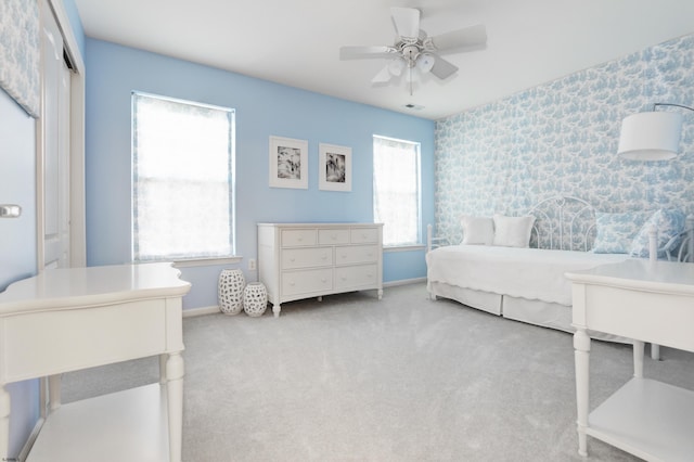 bedroom with ceiling fan, a closet, and light carpet