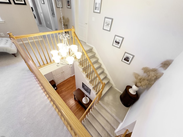 stairway featuring a chandelier and hardwood / wood-style flooring