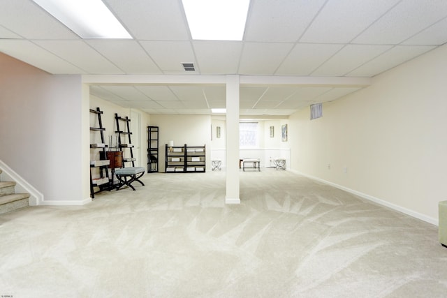 basement featuring carpet floors and a paneled ceiling