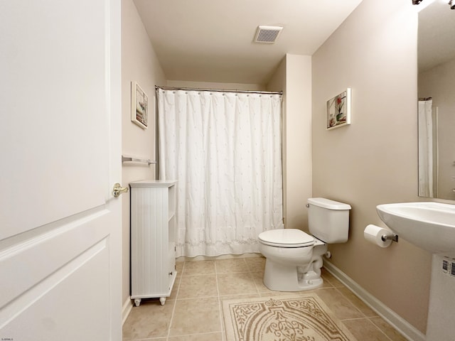 bathroom with radiator, tile patterned flooring, and toilet