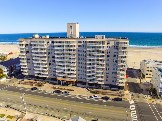 view of property featuring a water view and a beach view