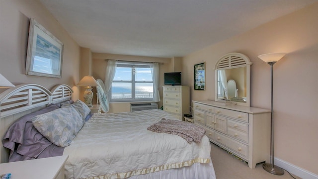 bedroom with light carpet and a wall unit AC