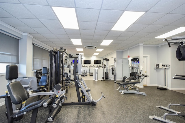 workout area featuring a paneled ceiling and ornamental molding