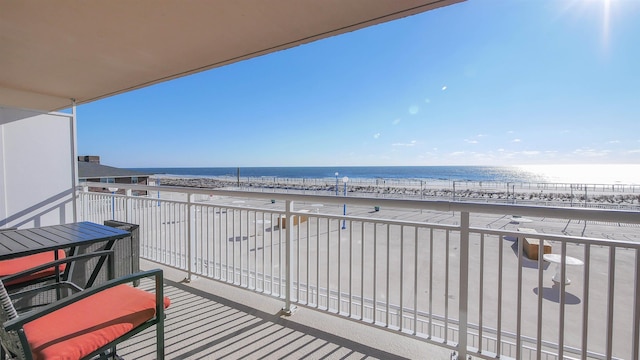 balcony with a water view and a beach view