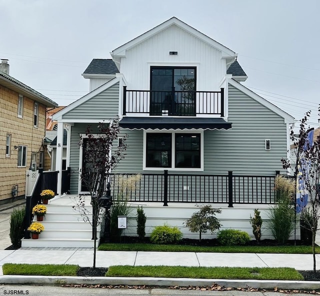 view of front of house with a porch and a balcony