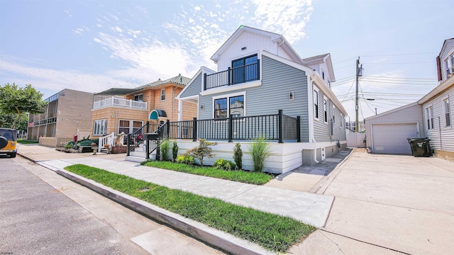 bungalow with an outbuilding, a balcony, and a garage