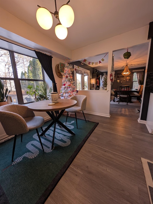 dining space with a chandelier and dark wood-type flooring