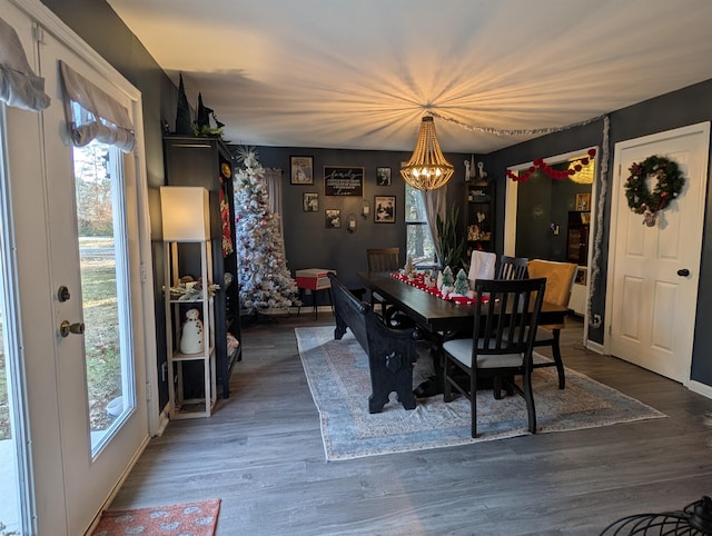 dining area with dark hardwood / wood-style flooring and a chandelier