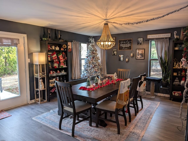 dining space with a chandelier and hardwood / wood-style floors