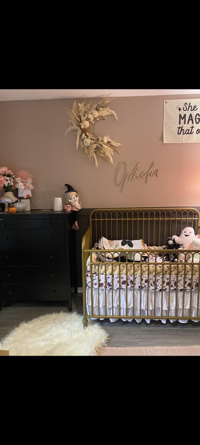 bedroom with a crib and carpet flooring