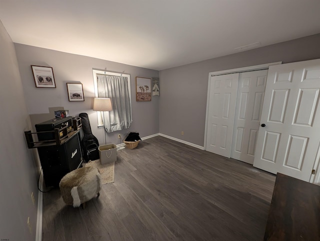 interior space with dark wood-type flooring and a closet