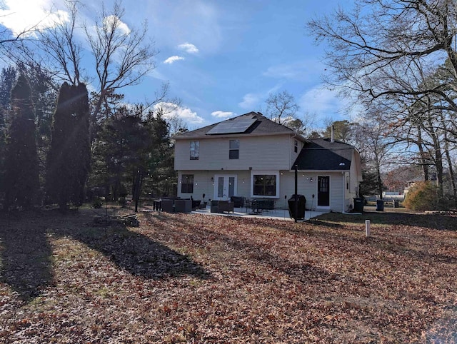 back of house featuring a patio area, french doors, and solar panels