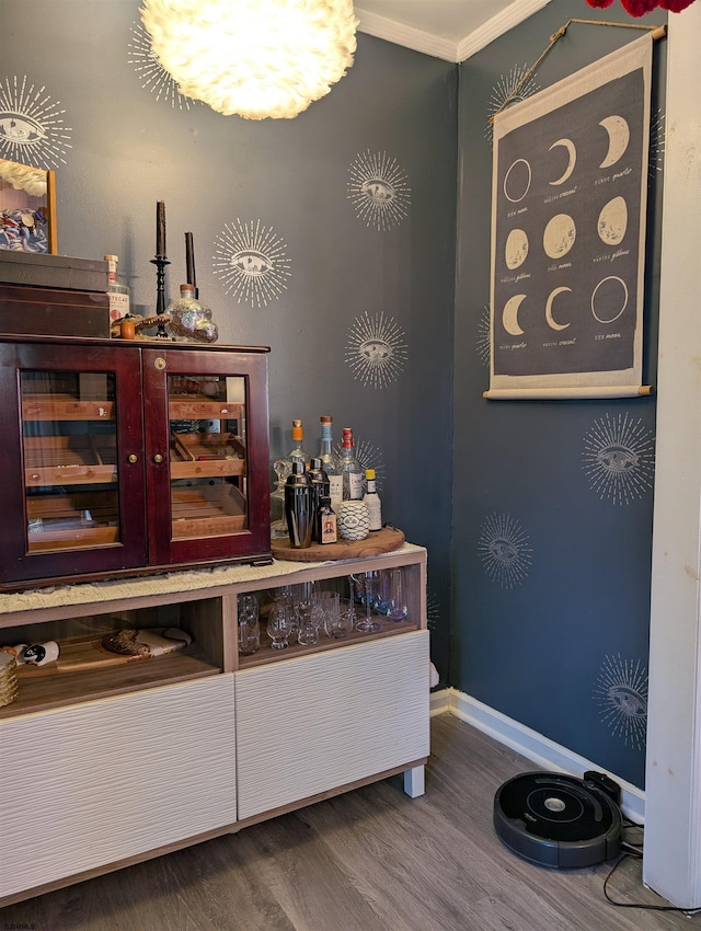 bar featuring hardwood / wood-style floors and crown molding