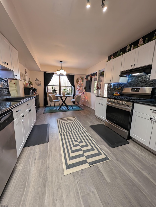 kitchen featuring light hardwood / wood-style flooring, stainless steel appliances, white cabinetry, and sink