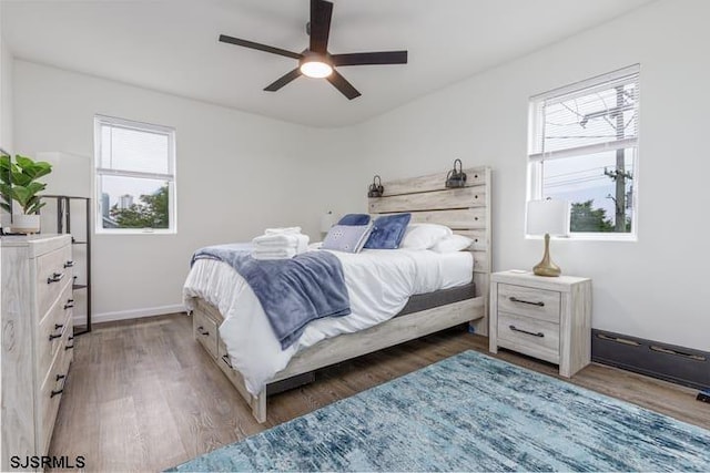 bedroom featuring ceiling fan and dark hardwood / wood-style floors