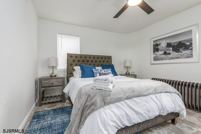 bedroom featuring ceiling fan and radiator