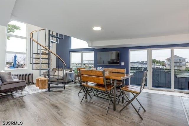 dining area featuring radiator and hardwood / wood-style floors