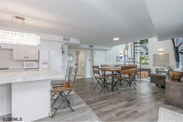 dining space featuring french doors and light hardwood / wood-style flooring