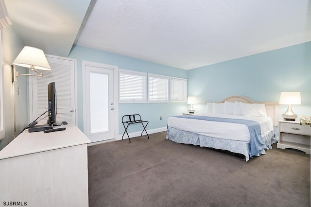 carpeted bedroom featuring a textured ceiling