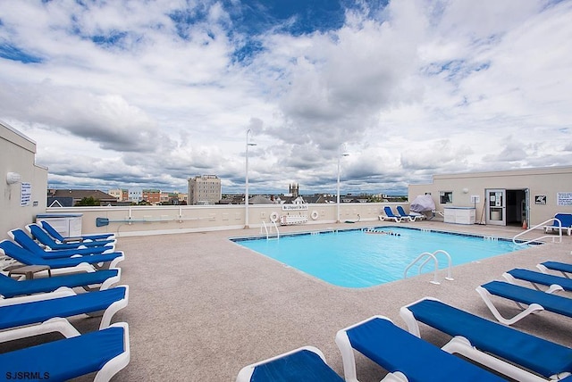 view of swimming pool featuring a patio area