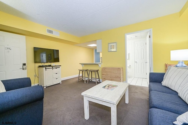 carpeted living room featuring a textured ceiling