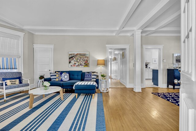 living room featuring beamed ceiling, ornate columns, hardwood / wood-style flooring, and coffered ceiling