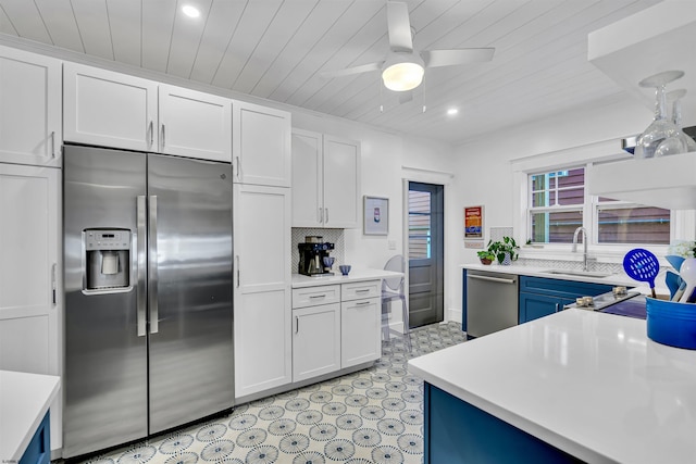 kitchen with appliances with stainless steel finishes, white cabinetry, and sink