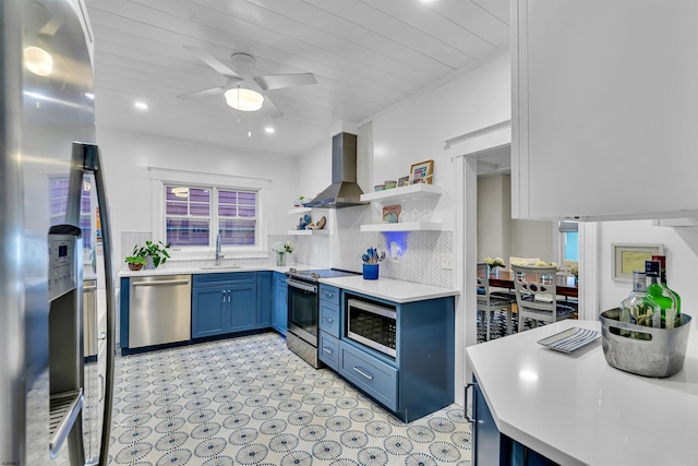 kitchen with sink, wall chimney exhaust hood, wooden ceiling, stainless steel appliances, and blue cabinets